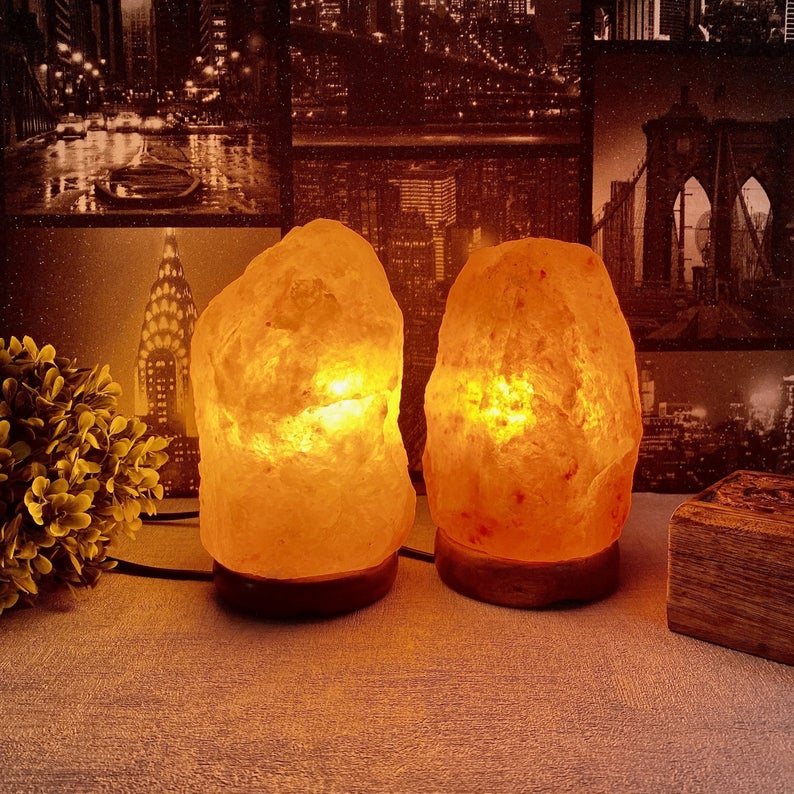 two pink himalayan salt lamps stood next to eachother